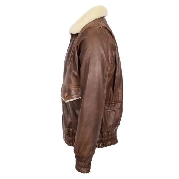 Angled view of a brown leather bomber jacket with a soft white shearling collar and elasticized waistband and cuffs, displayed against a white background