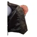 Close-up view of a hand holding open a black leather vest, showcasing the smooth inner lining and buttonhole details