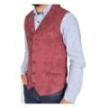 Angled view of a model wearing a Men's Suede Button Fastening Waistcoat Devin Burgundy with tan leather belt and dark blue jeans and blue dotted shirt under the vest