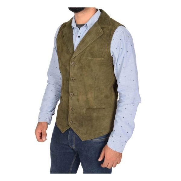 Angled view of a model wearing a Men's Suede Button Fastening Waistcoat Devin Green with tan leather belt and dark blue jeans and blue dotted shirt under the vest