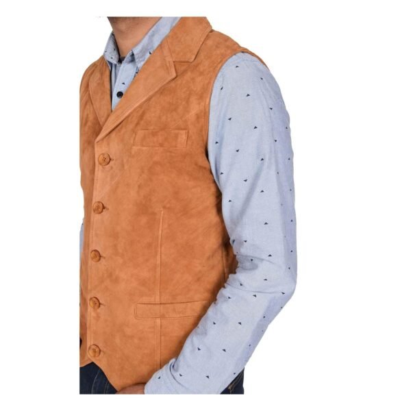 Angled view of a model wearing a Men's Suede Button Fastening Waistcoat Devin Tan with tan leather belt and dark blue jeans and blue dotted shirt under the vest