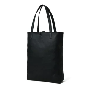 Angled view of the bottom of a black leather tote bag, showcasing its sturdy and flat base, against a white background